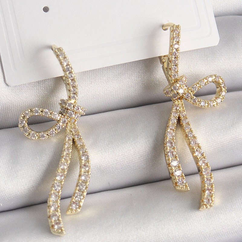 Pirinç Gold Renk Zirkon Taşlı Kurdele Model Kadın Küpe